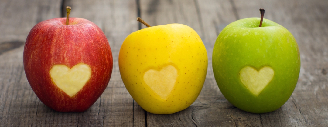 health and wellness - 3 apples with heart shapes cut out