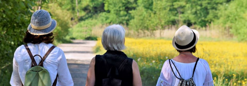 Women walking down country road, mixed ages