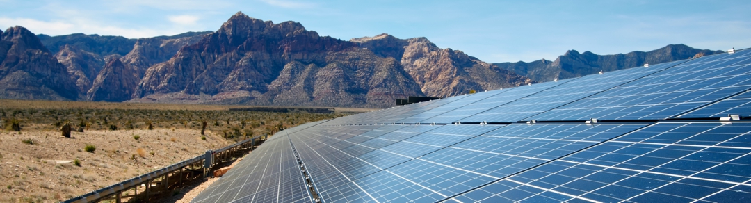 solar panels against a desert mountain background