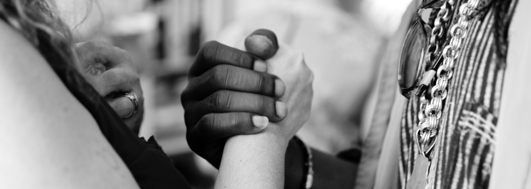 mixed ethnicities and gender clasping hands