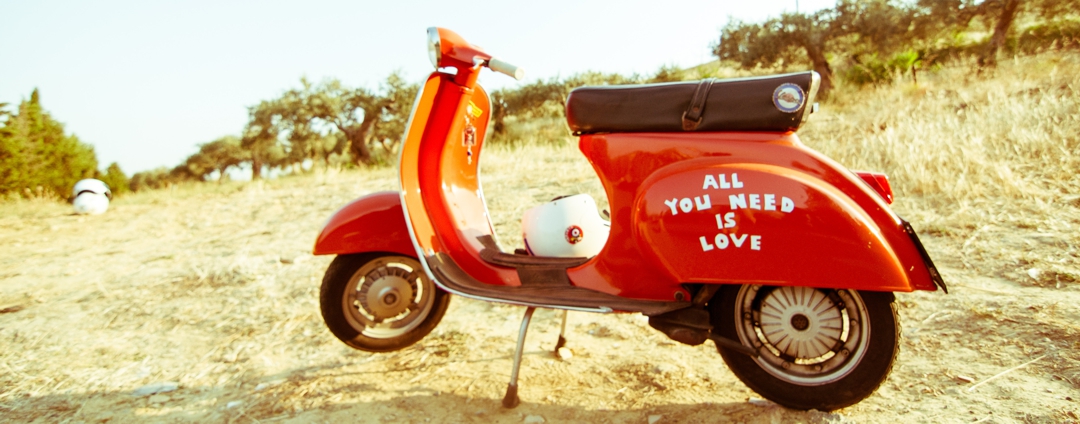 Motor scooter with words "all you need is love" written on the side