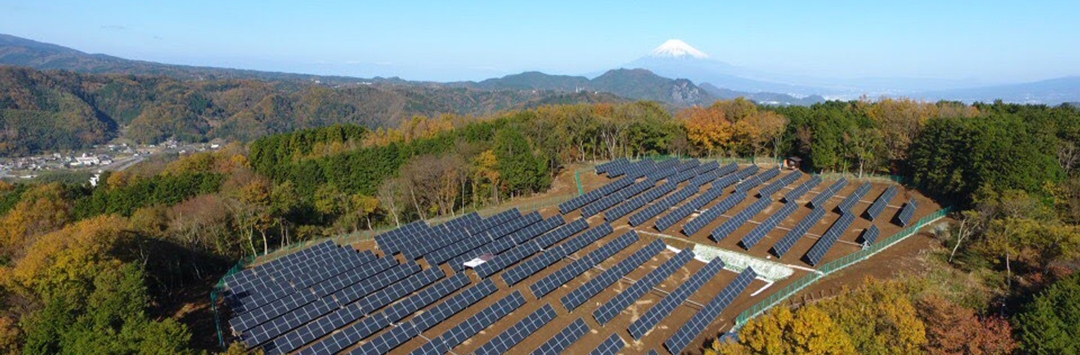 vast number of solar panels with mountains in background