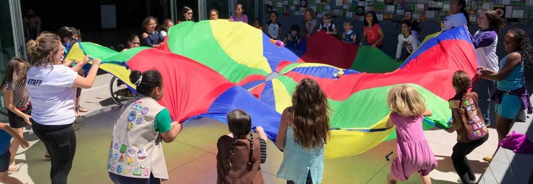 Girl Scouts circling parachute