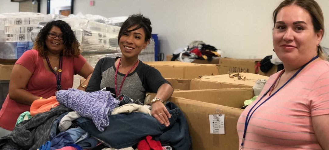 young women sorting clothing at thrift store