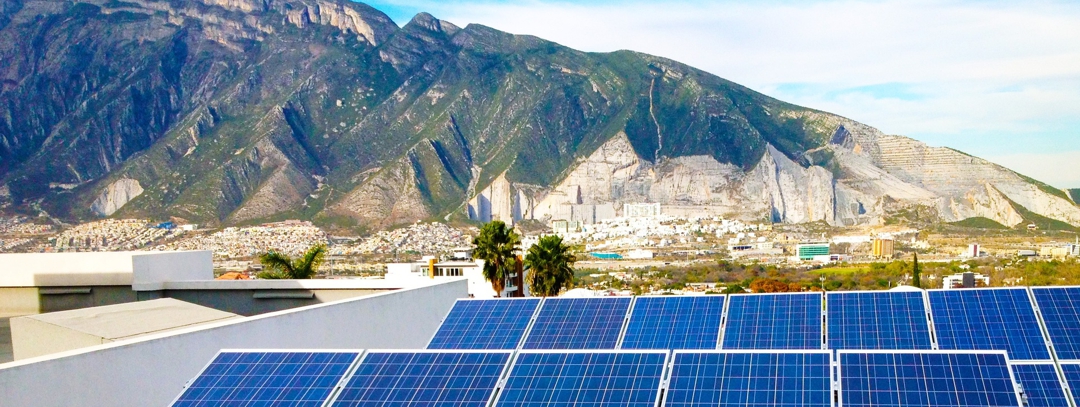 solar panels with city and mountains in background