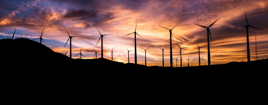 wind turbines against the sunset