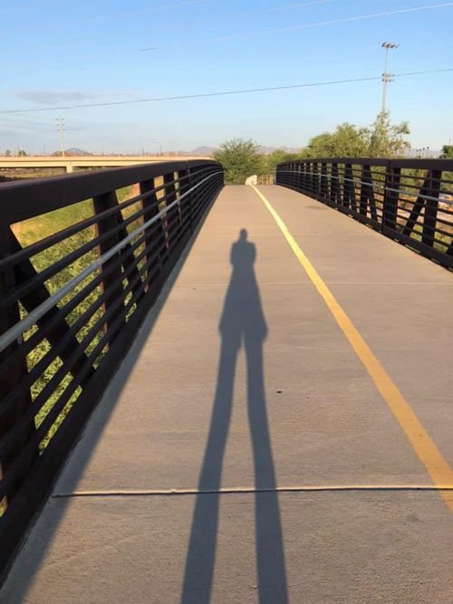 author taking photo of her shadow on bridge