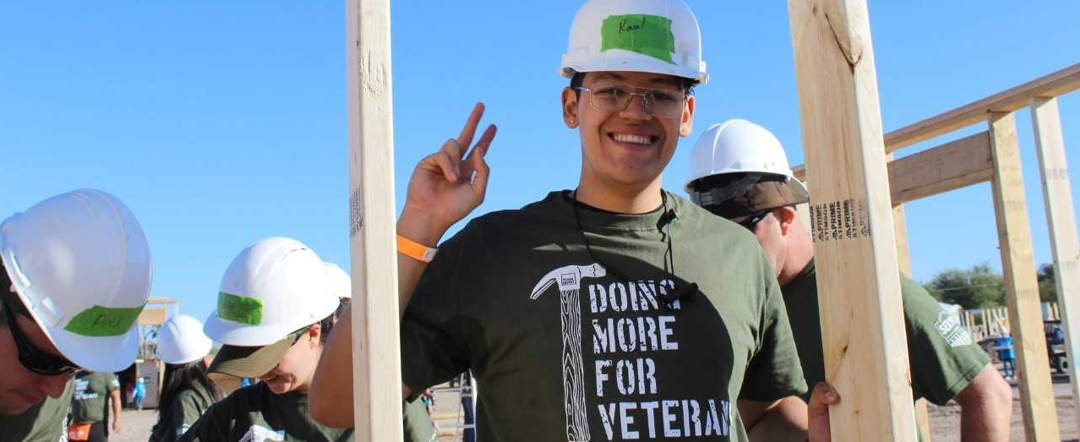 Young man wearing t-shirt that says "doing more for veterans".