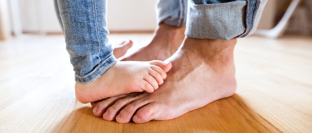 father and daughter bare feet dancing