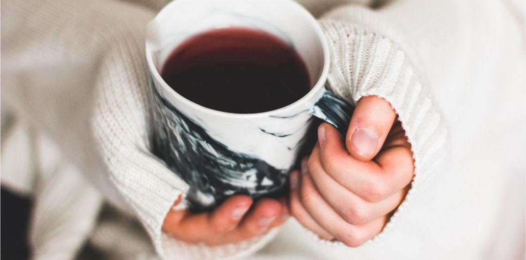 hands holding a mug of tea