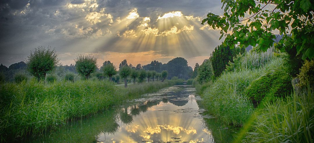 sun's rays bursting through clouds with re