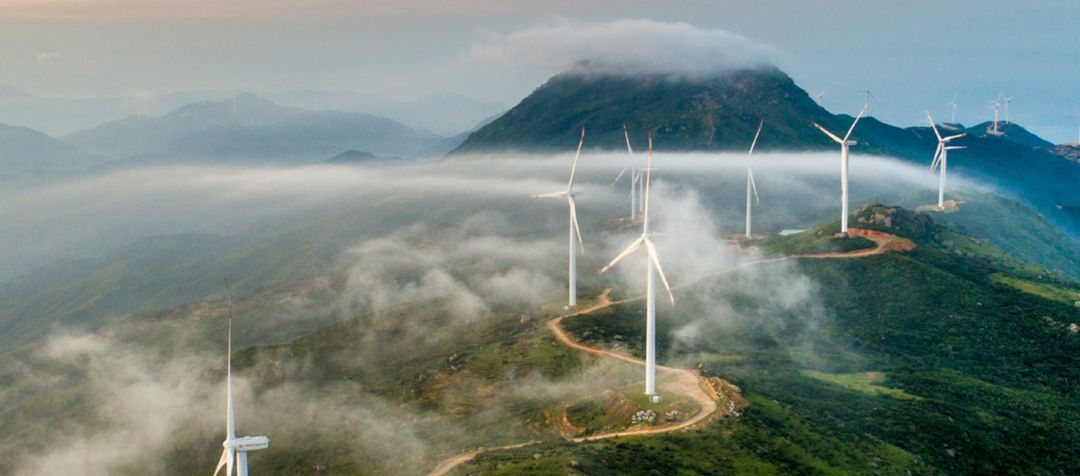 Wind turbines dotting the top of a mountain ridge