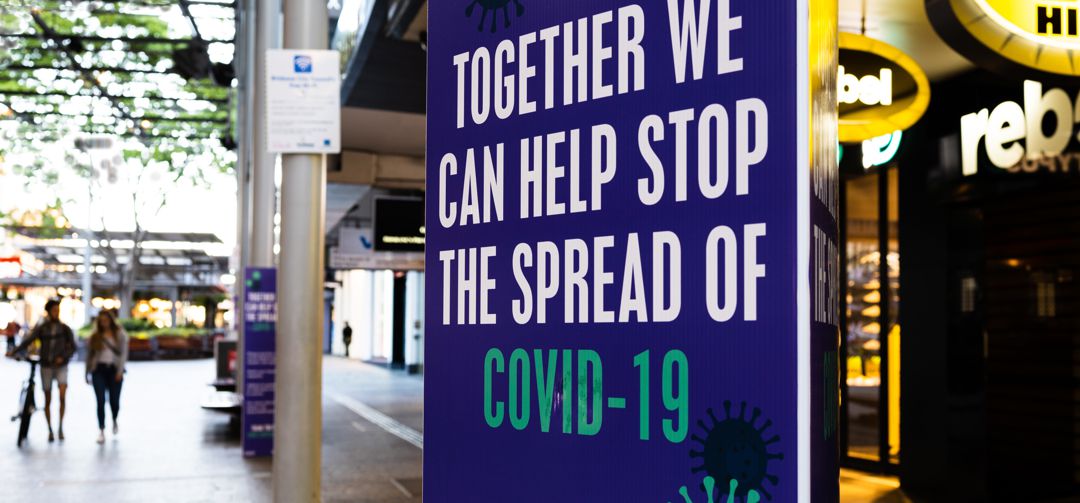 Street sign that says "together we can help stop the spread of covid-19"