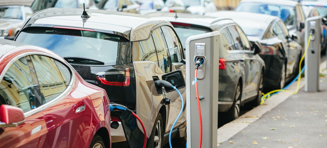 Electic vehicles plugged into public charging stations