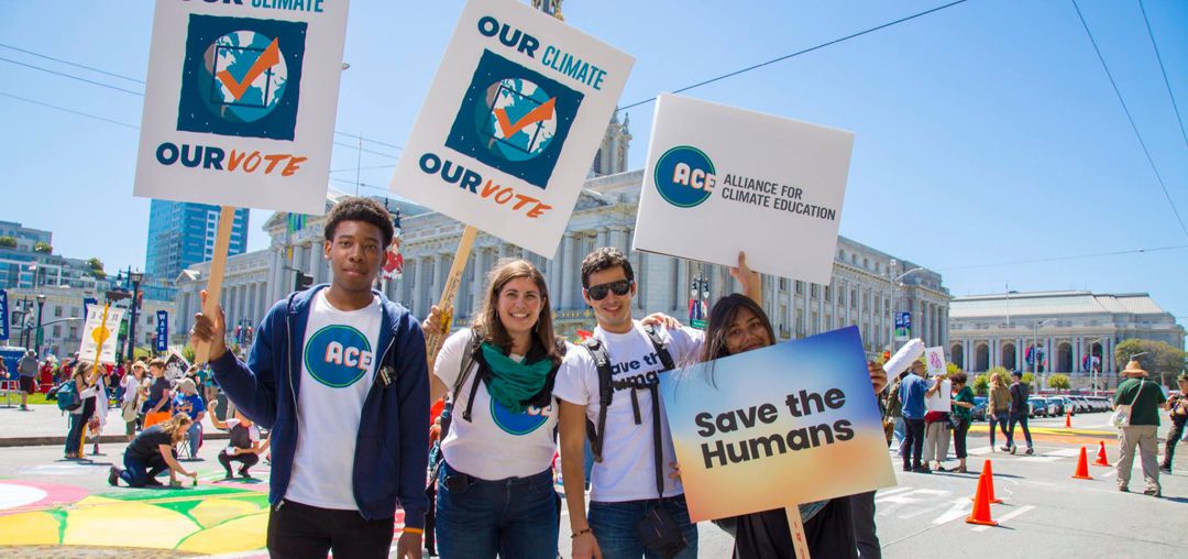 ACE Action for Climate Emergency youth holding signs