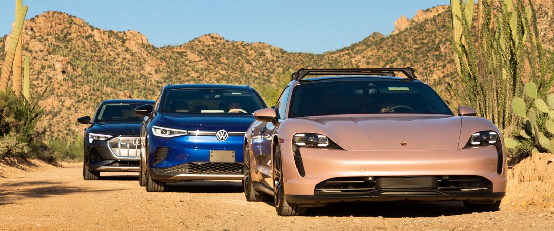 Electric vehicles in the desert with mountains in background