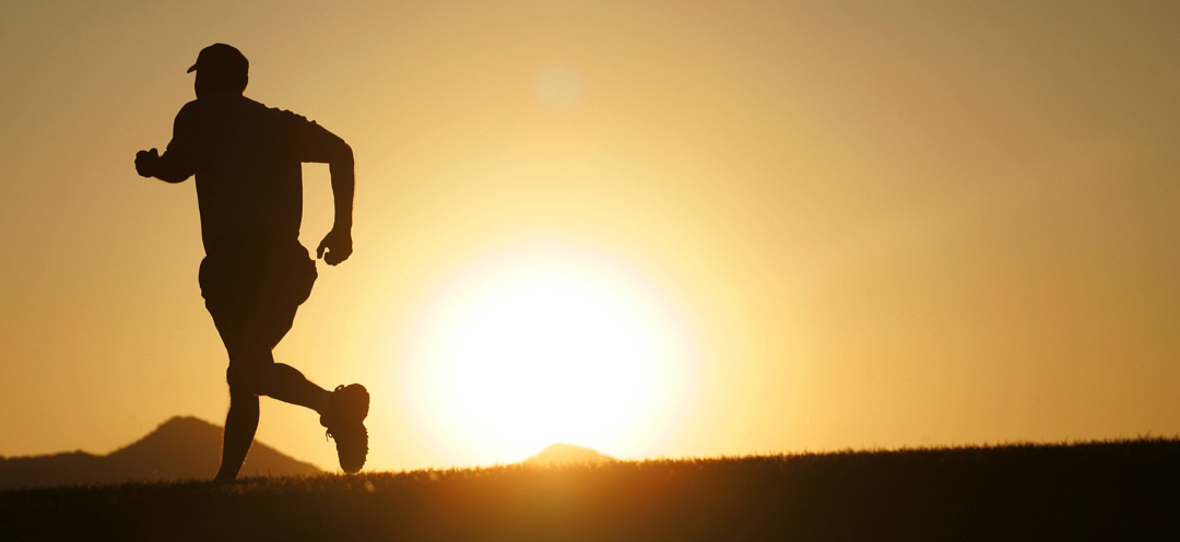 Man jogging in late afternoon desert sun